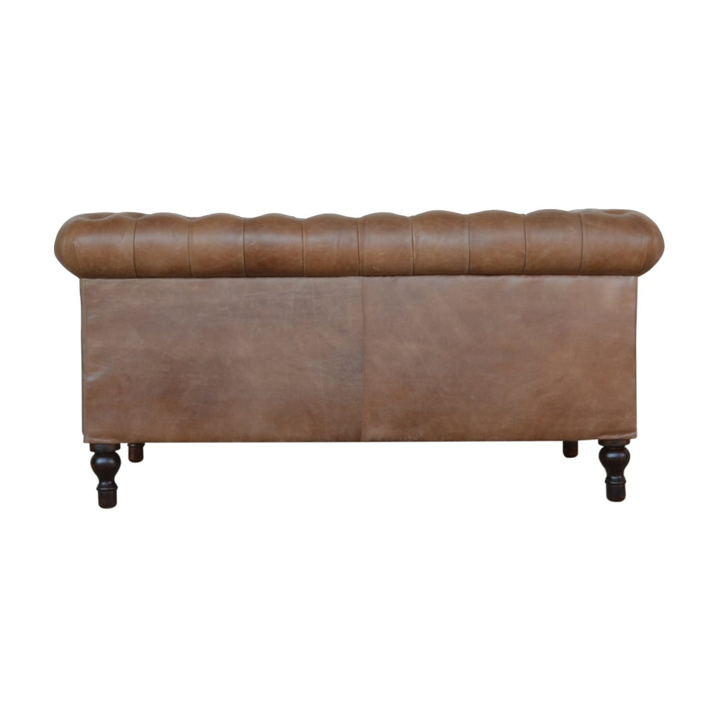 Chesterfield sofa with tailored piping and sheltering arms