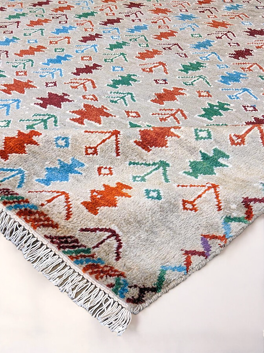 Geometric Ikat pattern detail on the tangerine wool rug