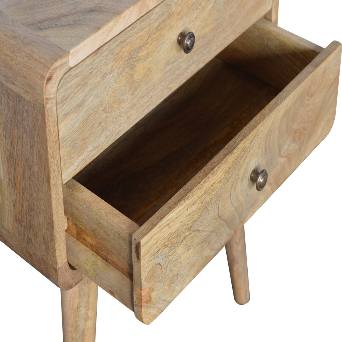 Natural mango wood grain on the curved nightstand